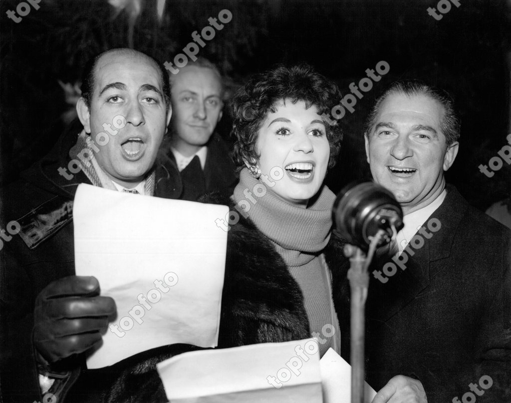 Comedian Alfred Marks Left And Singers Alma Cogan And Donald Peers Right Are Seen As They Joined With Other Television Stars In Singing Carols At London S