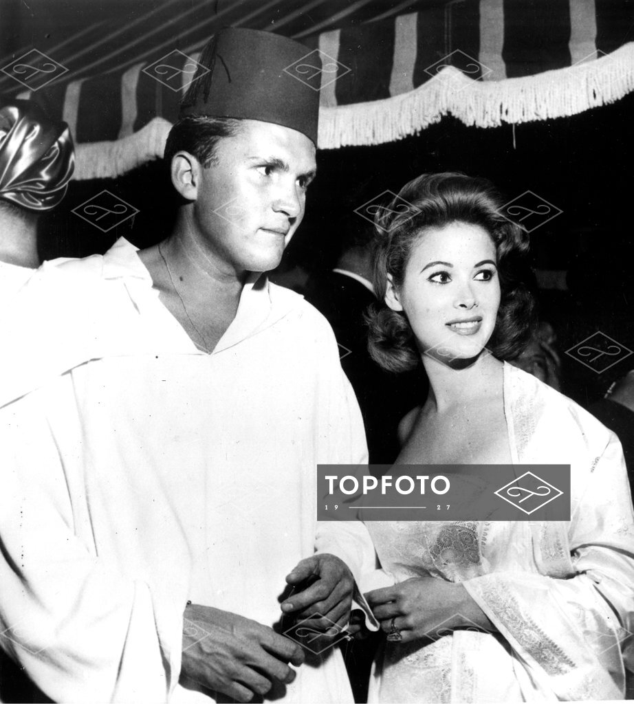 Wearing a fez, Playboy and race car enthusiasts Lance Reventlow and his  fiance, Jill St. John are shown as they attended the 