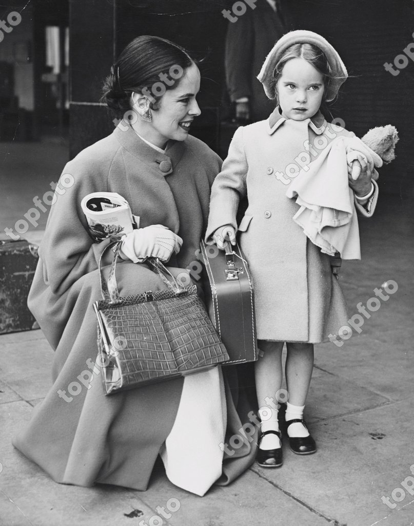 Gravely Holding Her Suitcase And Teddy Bear Five Year Old Victoria Is Welcomed By Her Mother