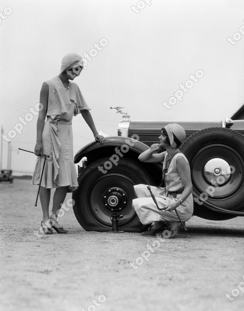 Woman Changing Flat Tire On Car Throw Pillow by H. Armstrong Roberts 