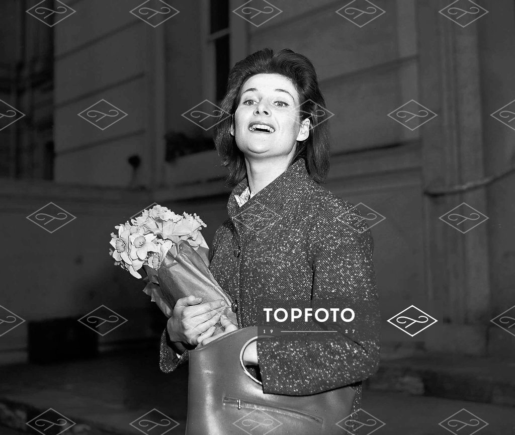 Actress Adrienne Corrie holding a bunch of flowers April 1956 - Topfoto  Image Archive