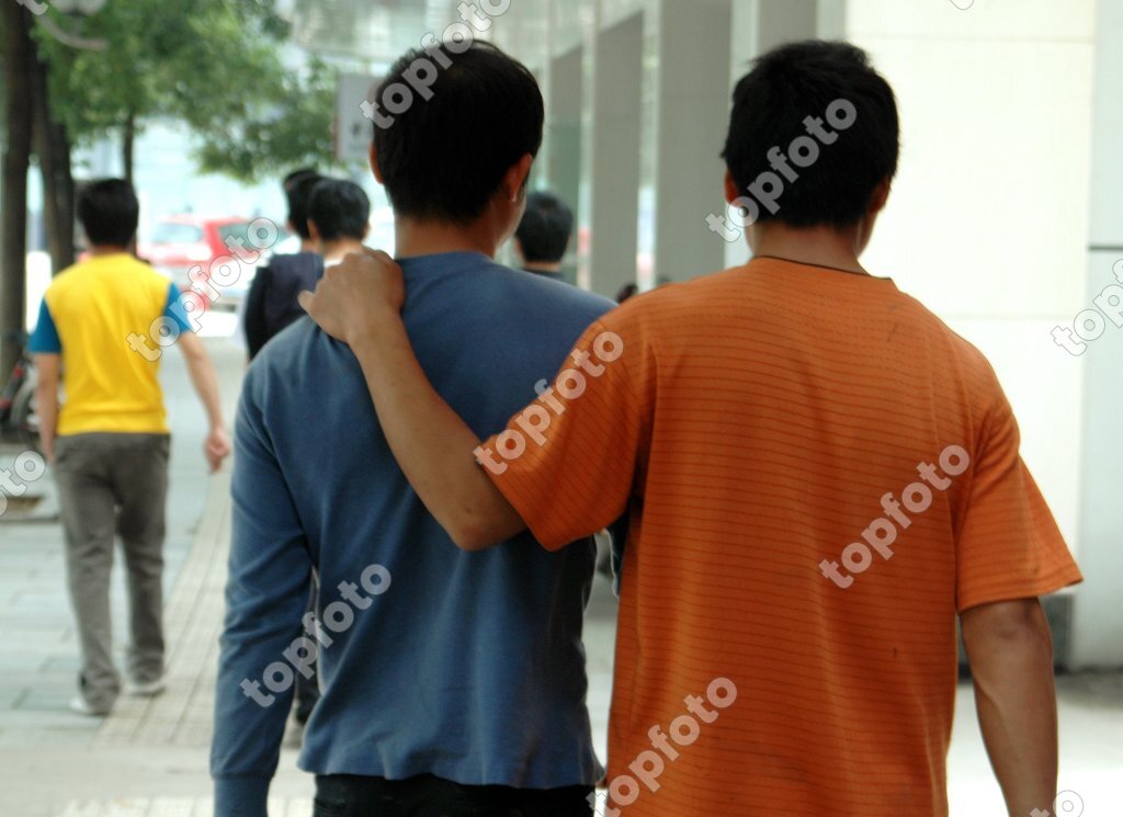 Guilin China Two Men Walking On Zhengyang Street Chinese Men Often Walk Arm In Arm Or With A Hand On The Shoulder Topfoto