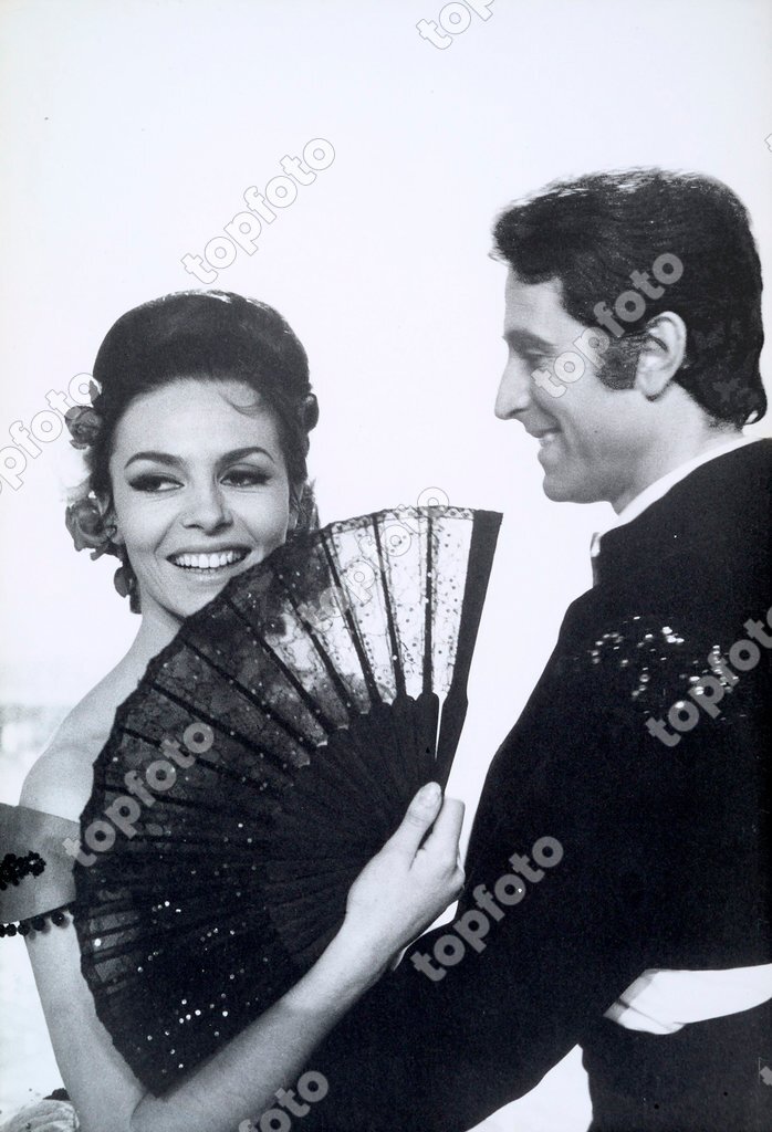 Portrait of the actress Michele Mercier with a fan smiling and