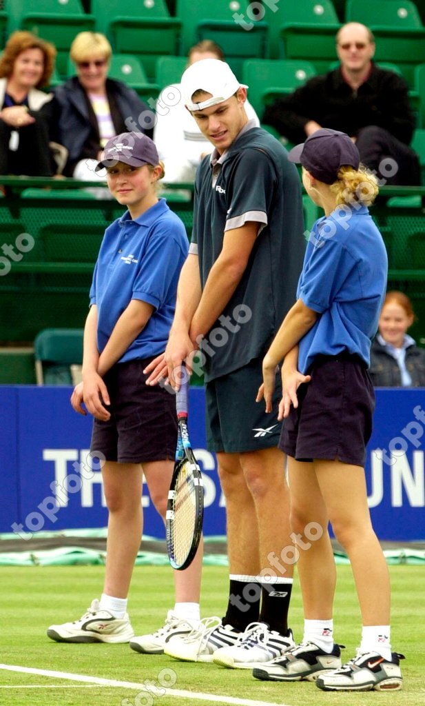 USA s Andy Roddick enjoys a light moment with ball girls before a