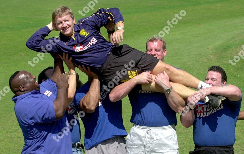 Wimbledon Manager Terry Burton is lifted by Maximuscle sponsored